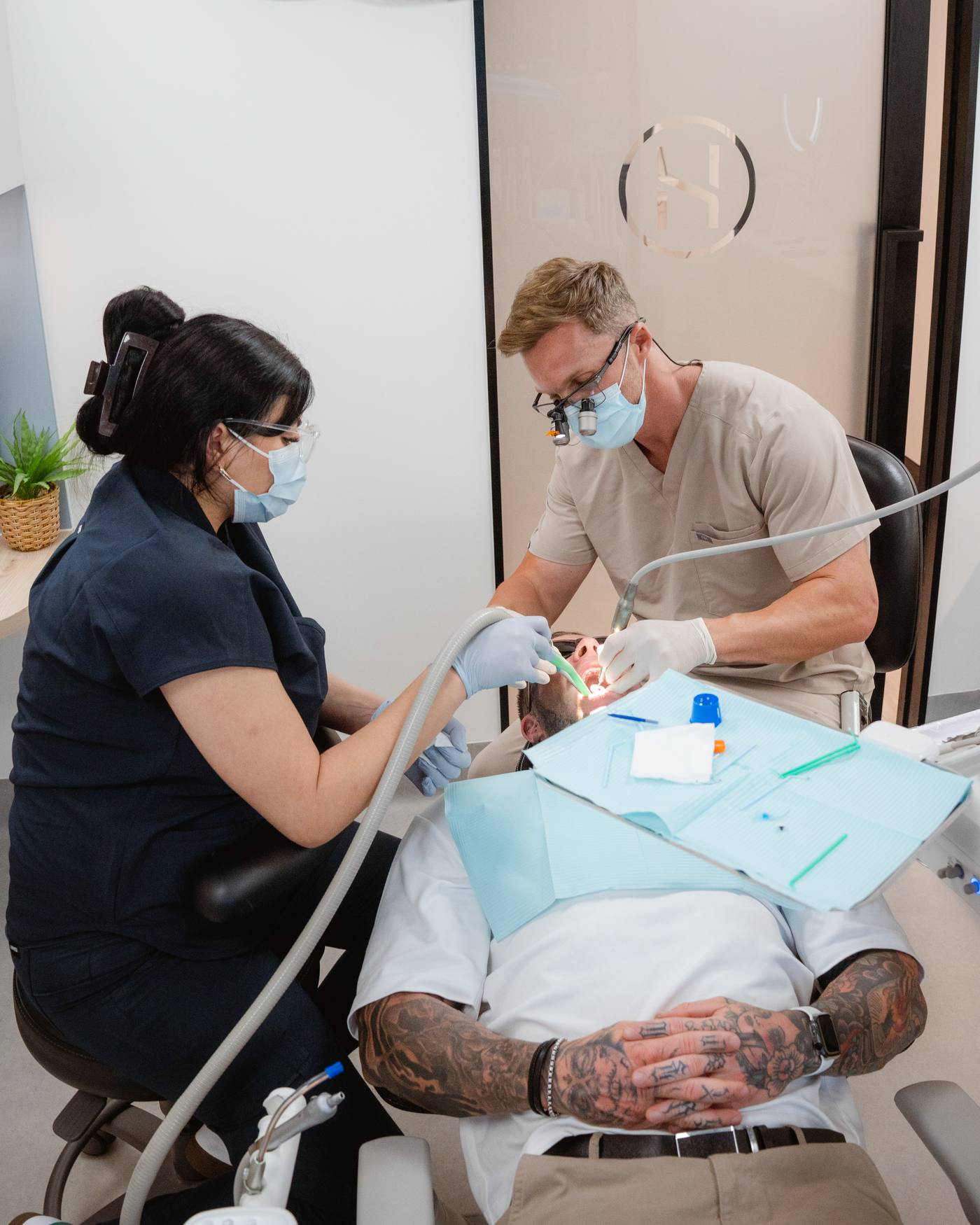 Dr Matt Hedge and a dental assistant treating a patient at Helix Dental, Mermaid Waters